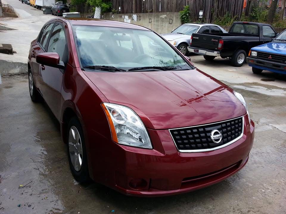 The same red car, completely restored and refinished